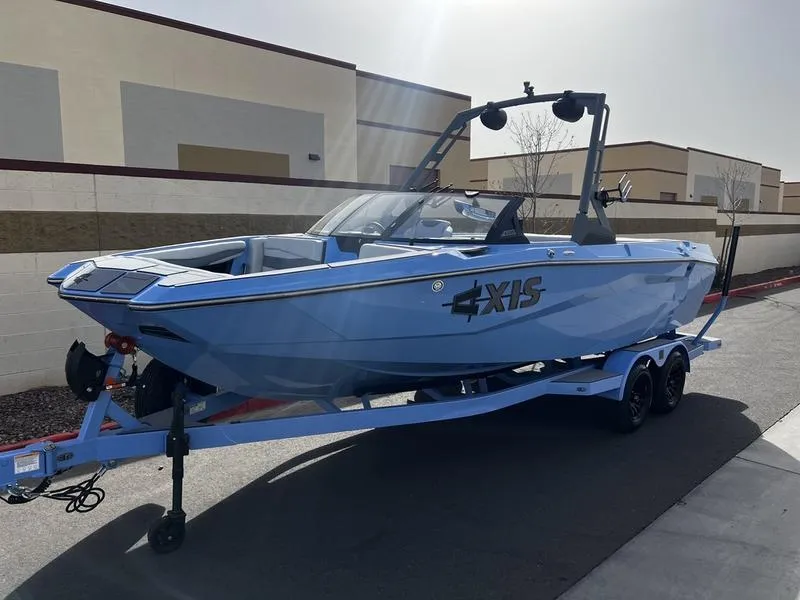 Slide: The Image of 2025 Axis A225 boat on trailer, parked outdoors, side view. - 2