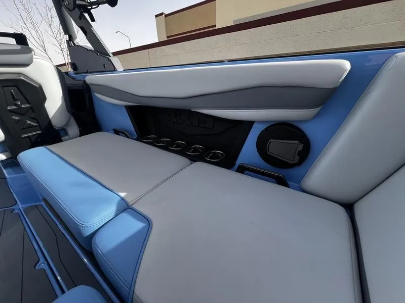 Slide: The Image of Interior of 2025 Axis A225 boat with blue and gray seating. - 20