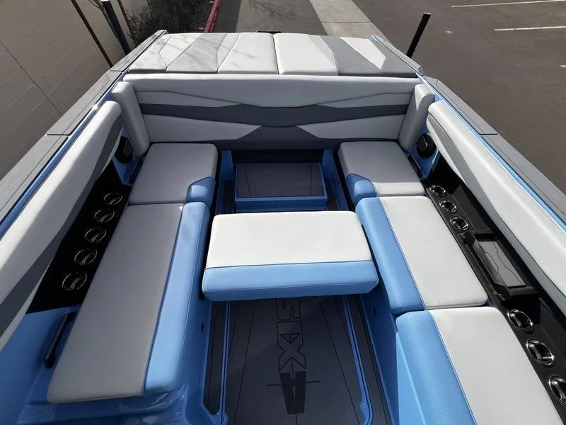 Slide: The Image of Luxurious seating area on 2025 Axis A225 boat with blue and gray upholstery. - 21
