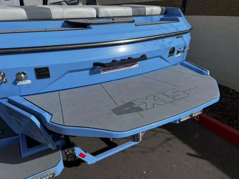 Slide: The Image of 2025 Axis A225 boat with blue exterior and gray swim platform. - 5