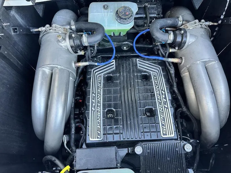 Slide: The Image of 2021 Malibu 24 MXZ engine with supercharged components and dual exhaust manifolds. - 1