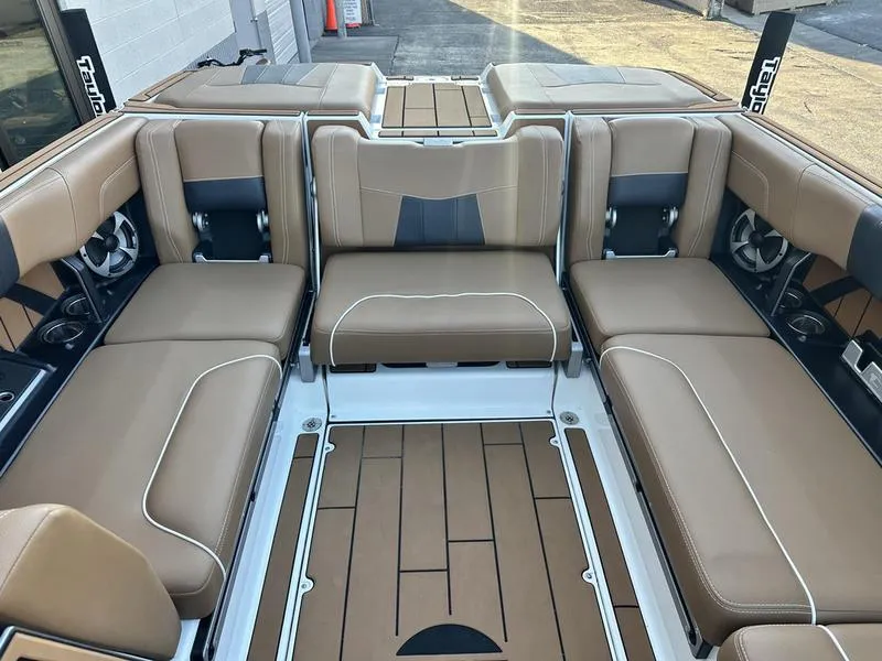 Slide: The Image of 2021 Malibu 24 MXZ boat interior with tan leather seating and sleek design. - 10