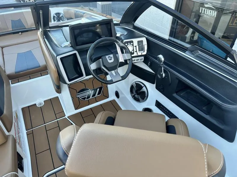 Slide: The Image of 2021 Malibu 24 MXZ boat interior with modern dashboard and steering wheel. - 14