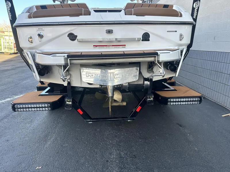 Slide: The Image of 2021 Malibu 24 MXZ boat rear view with propeller and swim platform. - 6