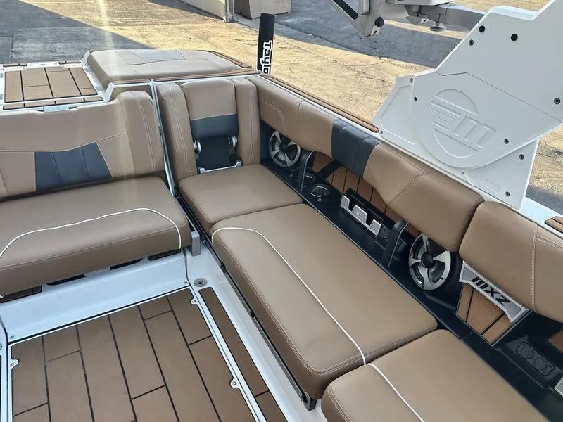 Slide: The Image of 2021 Malibu 24 MXZ boat interior with tan leather seating and modern design. - 9