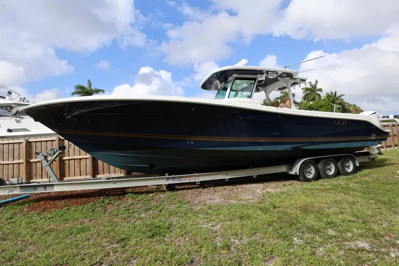 Slide: The Image of 2020 HCB Speciale boat on trailer, parked outdoors under a partly cloudy sky. - 34