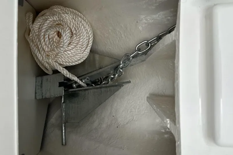 Slide: The Image of Anchor and rope storage in 2024 Bayliner DX 2250 boat compartment. - 15