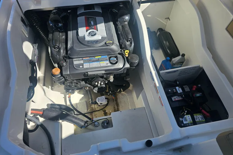Slide: The Image of 2024 Bayliner DX 2250 engine compartment with visible motor and battery setup. - 16