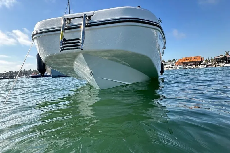 Slide: The Image of 2024 Bayliner DX 2250 boat on water, showcasing sleek hull design. - 4