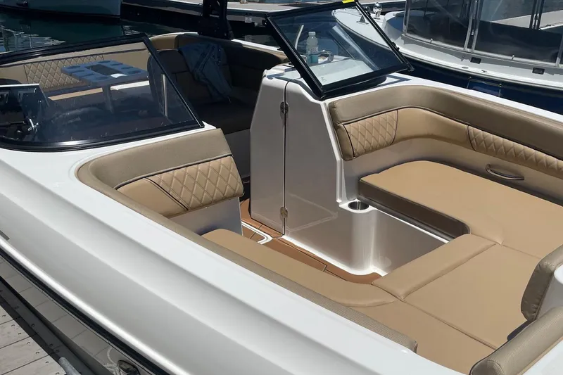 Slide: The Image of 2024 Bayliner DX 2250 boat interior with beige seating and modern design. - 8