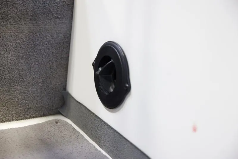 Slide: The Image of Interior detail of a 2014 Malibu 247 LSV boat, featuring a black circular vent. - 11