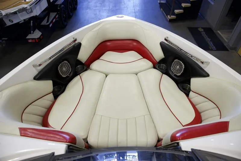 Slide: The Image of 2014 Malibu 247 LSV boat interior with white and red seating. - 12