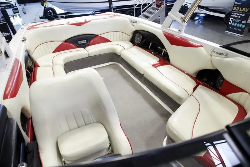 Slide: The Image of 2014 Malibu 247 LSV boat interior with white and red seating, spacious layout. - 13