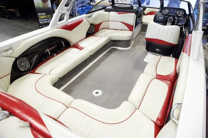 Slide: The Image of 2014 Malibu 247 LSV boat interior with red and white seating, spacious layout. - 14
