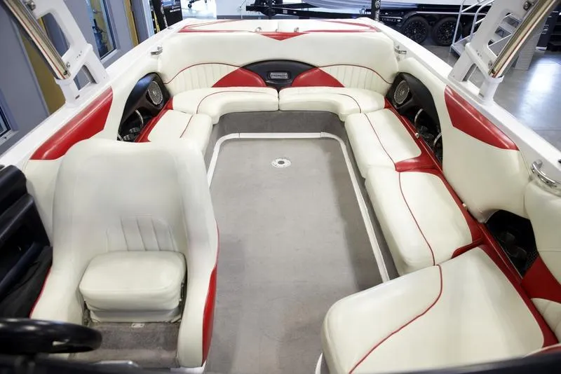 Slide: The Image of 2014 Malibu 247 LSV boat interior with white and red seating. - 15