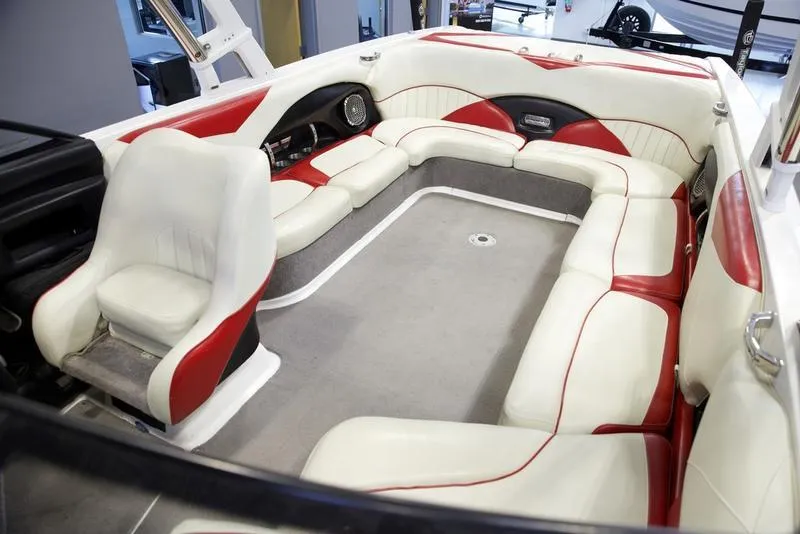 Slide: The Image of 2014 Malibu 247 LSV boat interior with white and red seating. - 16