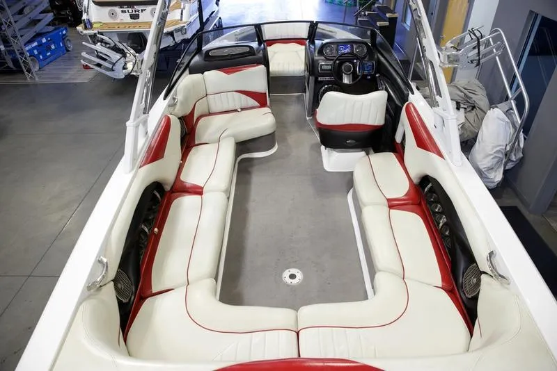 Slide: The Image of 2014 Malibu 247 LSV boat interior with red and white seating, spacious layout. - 6