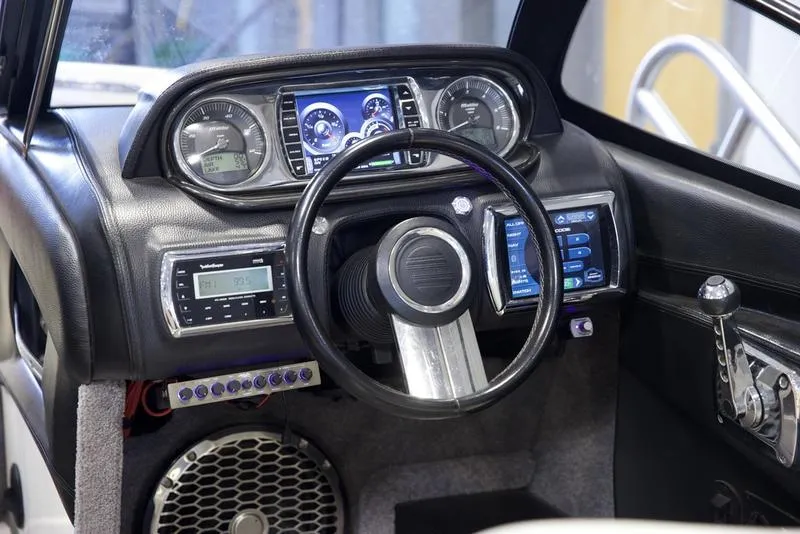 Slide: The Image of 2014 Malibu 247 LSV dashboard with modern controls and sleek steering wheel design. - 9