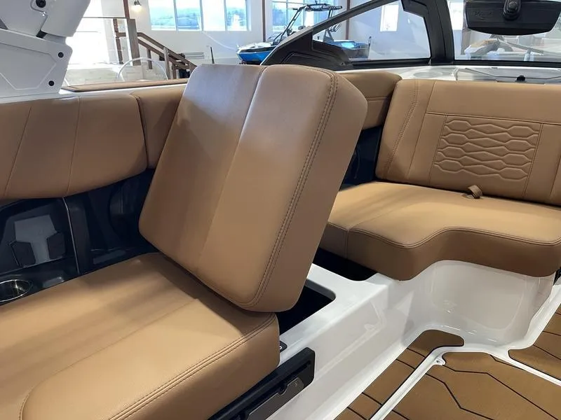 Slide: The Image of 2025 Malibu 23 MXZ boat interior with tan leather seating and modern design. - 16