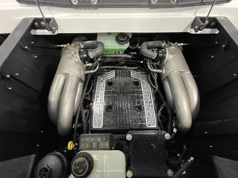 Slide: The Image of 2025 Malibu 23 MXZ engine compartment showcasing powerful dual exhaust system. - 25