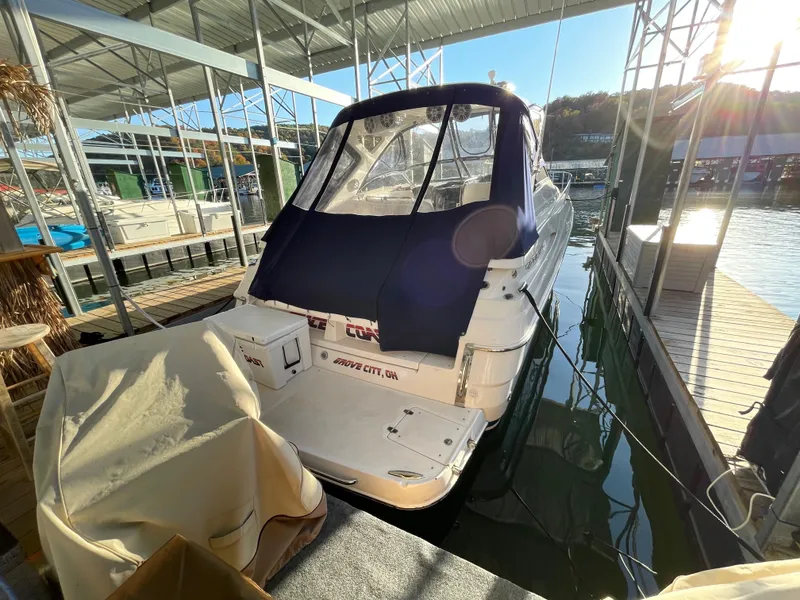 Slide: The Image of 2006 Regal Commodore 3560 IO docked in a marina under a covered slip. - 2