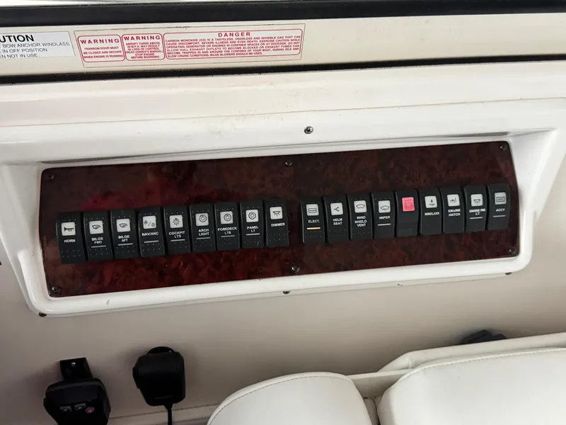 Slide: The Image of Control panel of a 2006 Regal Commodore 3560 IO boat with labeled switches. - 23