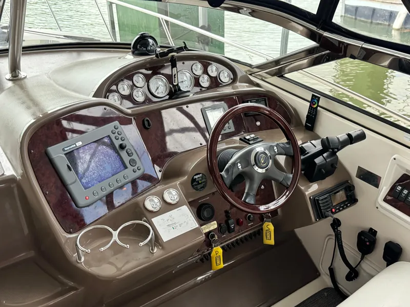 Slide: The Image of Helm of 2006 Regal Commodore 3560 IO with navigation instruments and steering wheel. - 3