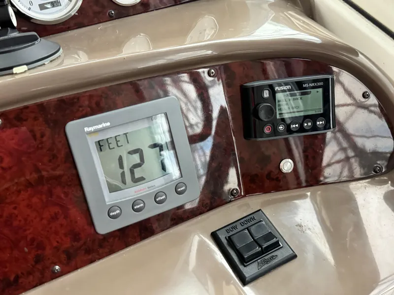 Slide: The Image of Control panel of 2006 Regal Commodore 3560 IO boat with depth gauge and audio system. - 33