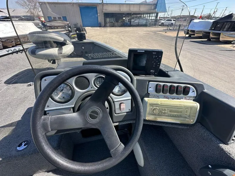 Slide: The Image of 2014 Alumacraft Competitor 175 CS dashboard with steering wheel and control panel. - 10