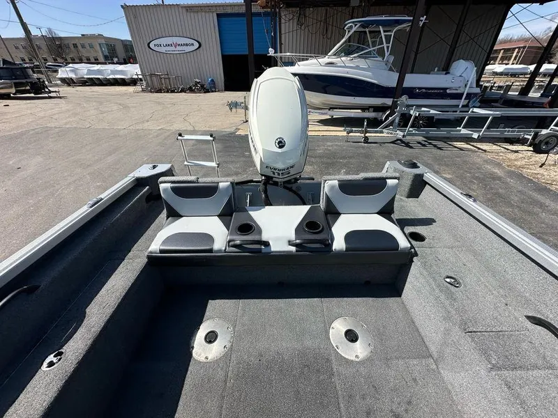 Slide: The Image of 2014 Alumacraft Competitor 175 CS boat interior with seating and Evinrude motor at Fox Lake Harbor. - 13