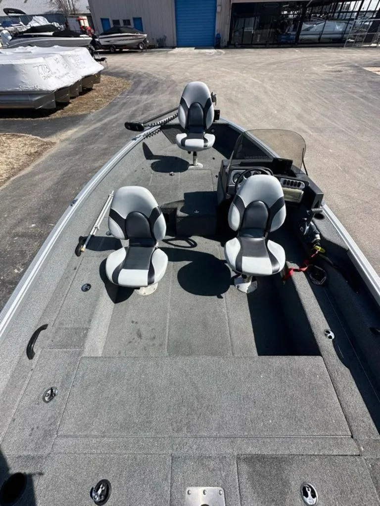 Slide: The Image of 2014 Alumacraft Competitor 175 CS boat interior with three seats and steering console. - 3