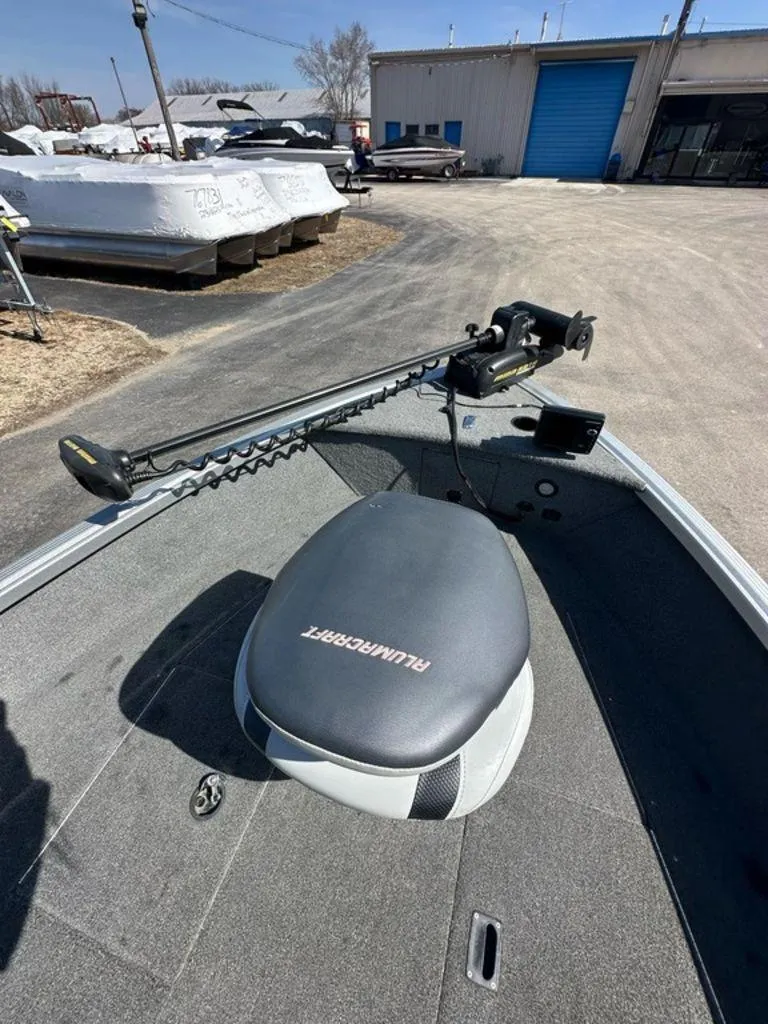Slide: The Image of 2014 Alumacraft Competitor 175 CS boat with trolling motor in a storage yard. - 4