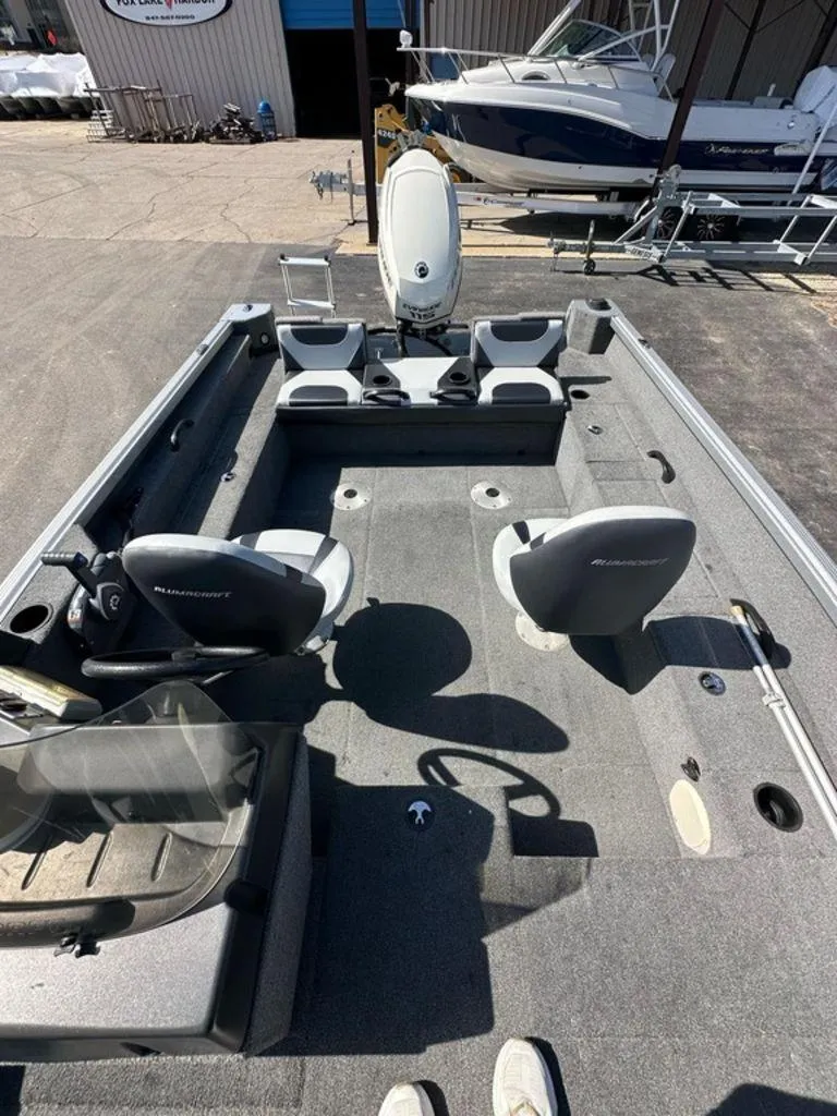 Slide: The Image of 2014 Alumacraft Competitor 175 CS fishing boat interior with seating and storage compartments. - 8