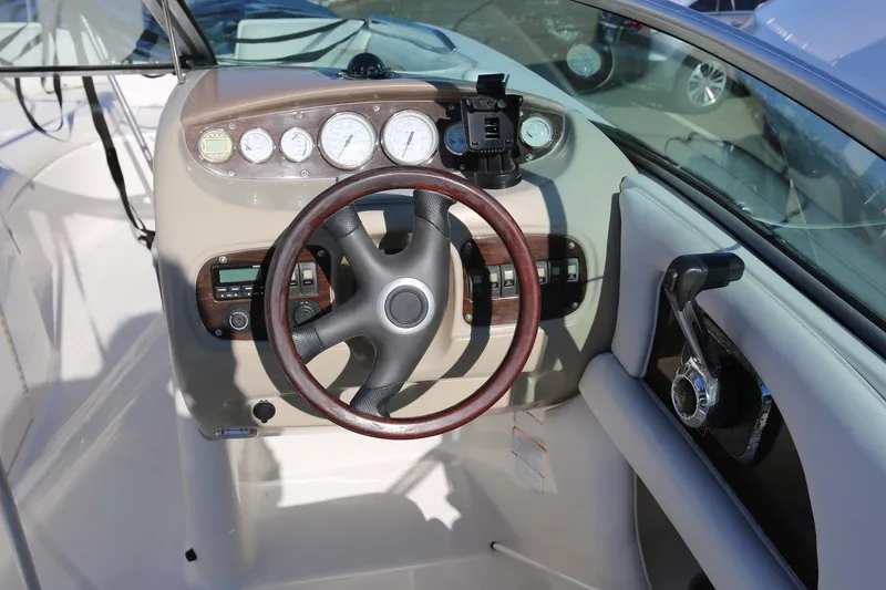 Slide: The Image of 2005 Chaparral 236 Sunesta boat dashboard with steering wheel and gauges. - 13