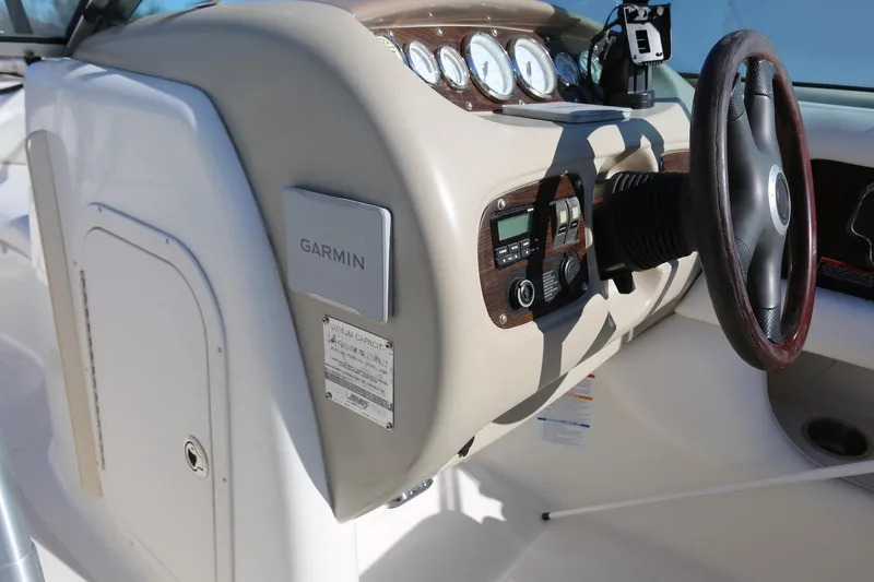 Slide: The Image of 2005 Chaparral 236 Sunesta dashboard with Garmin navigation system and steering wheel. - 14