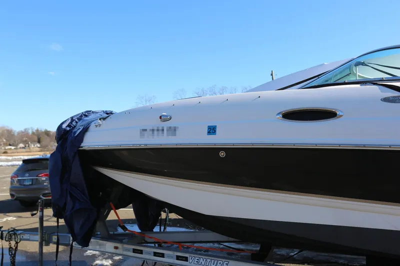 Slide: The Image of 2005 Chaparral 236 Sunesta boat on trailer, partially covered, outdoors. - 18