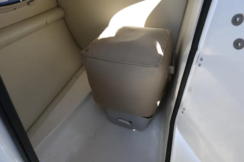 Slide: The Image of 2005 Chaparral 236 Sunesta interior with beige seating and storage compartment. - 25