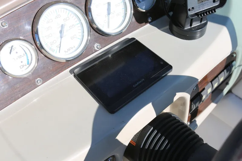 Slide: The Image of Dashboard of 2005 Chaparral 236 Sunesta with gauges and Garmin device. - 26