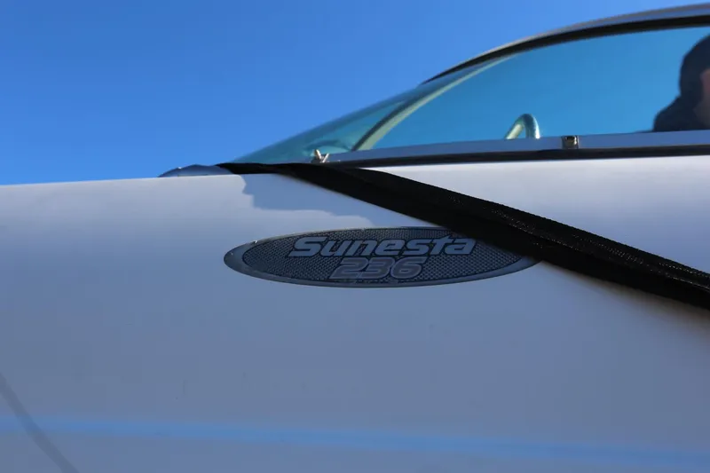 Slide: The Image of 2005 Chaparral 236 Sunesta boat emblem against clear blue sky. - 28