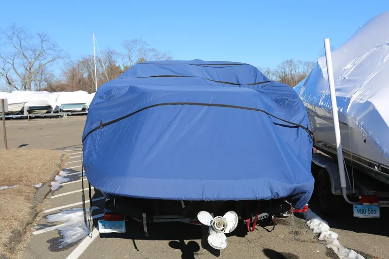 Slide: The Image of Covered 2005 Chaparral 236 Sunesta boat with SeaKeeper and trailer in parking lot. - 29
