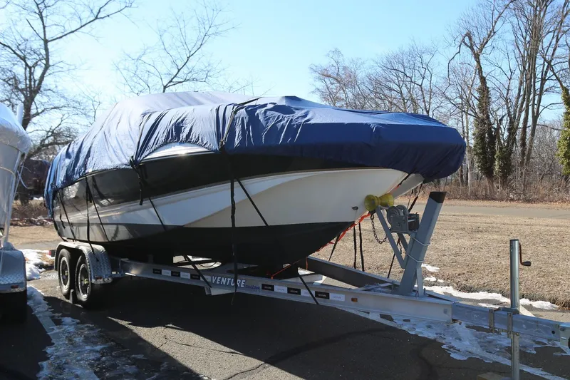 Slide: The Image of 2005 Chaparral 236 Sunesta boat on trailer, covered, parked outdoors. - 30