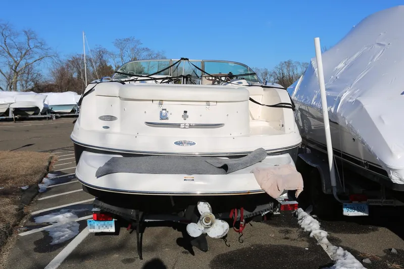 Slide: The Image of 2005 Chaparral 236 Sunesta boat with SeaKeeper and trailer, parked outdoors. - 6