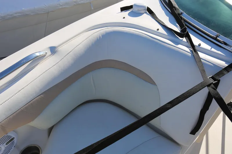 Slide: The Image of 2005 Chaparral 236 Sunesta boat interior with white seating and black straps. - 8