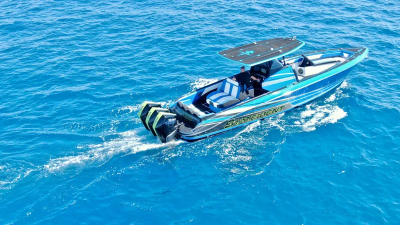 Slide: The Image of 2023 Statement 380 Open boat cruising on blue ocean waters. - 12