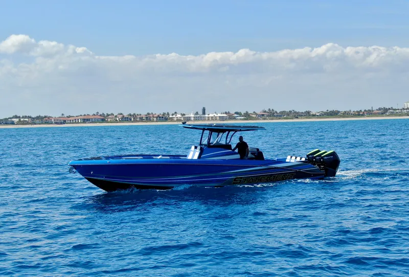 Slide: The Image of 2023 Statement 380 Open boat cruising on clear blue ocean waters. - 13