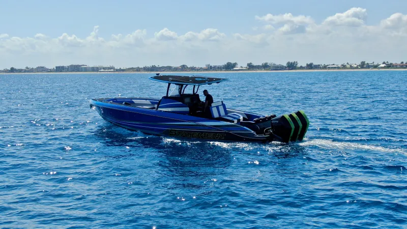 Slide: The Image of 2023 Statement 380 Open boat cruising on clear blue ocean waters. - 14