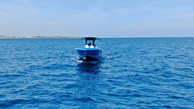 Slide: The Image of 2023 Statement 380 Open boat cruising on clear blue ocean waters. - 17