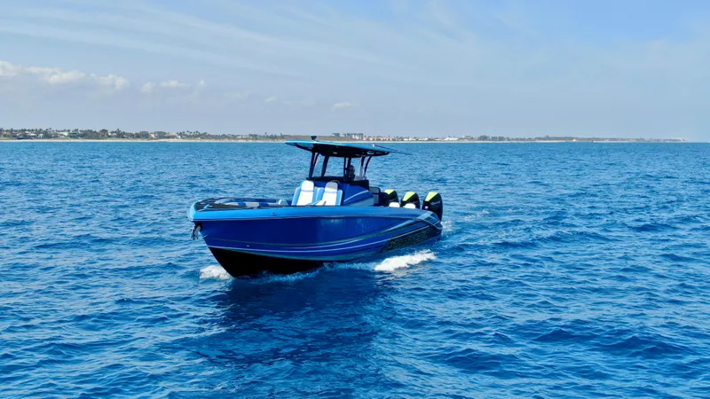 Slide: The Image of 2023 Statement 380 Open boat cruising on clear blue ocean waters. - 18