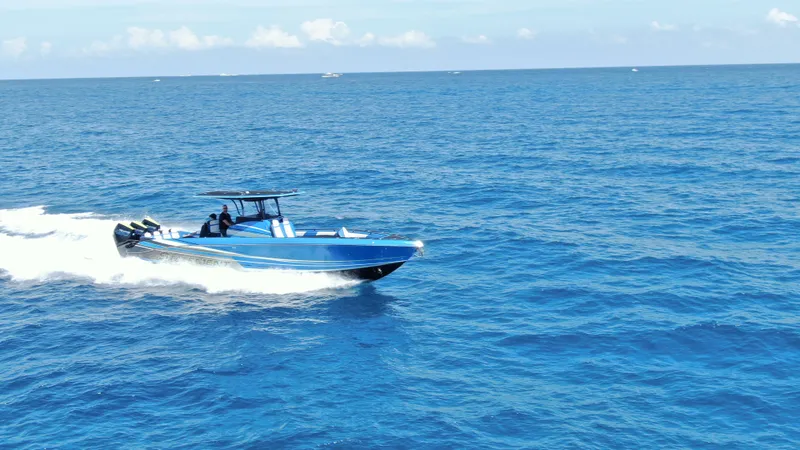 Slide: The Image of 2023 Statement 380 Open boat cruising on open sea, clear blue water, sunny day. - 21