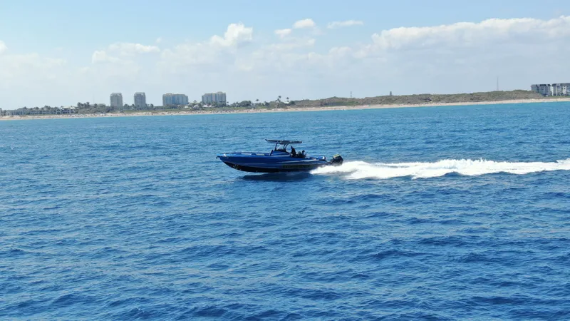 Slide: The Image of 2023 Statement 380 Open boat speeding on open blue ocean waters. - 24